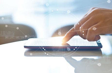 Hand of stock investment using smartphone for checking worldwide stock exchanges interface on screen with graphic icons, soft focus