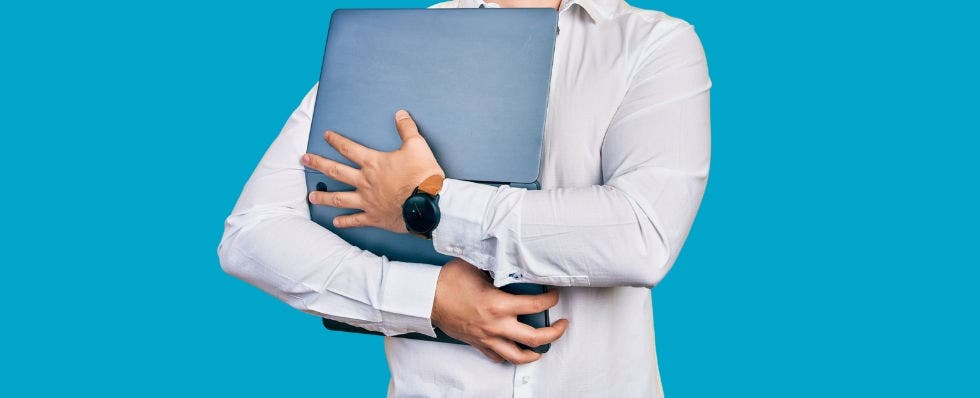 a man hugging a laptop